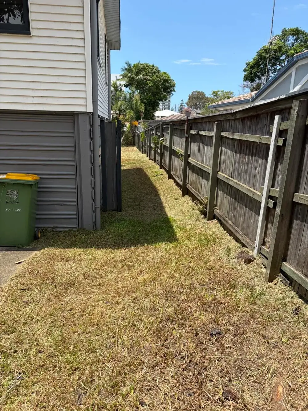 Same narrow side lawn after mowing